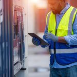 International shipping logistics, Logistics workers of forwarder with tablet inspect cargo.